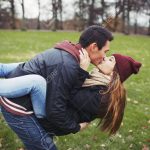 25973406-Attractive-young-man-carrying-his-pretty-girlfriend-and-kissing-Mixed-race-couple-in-love-outdoors-i-Stock-Photo